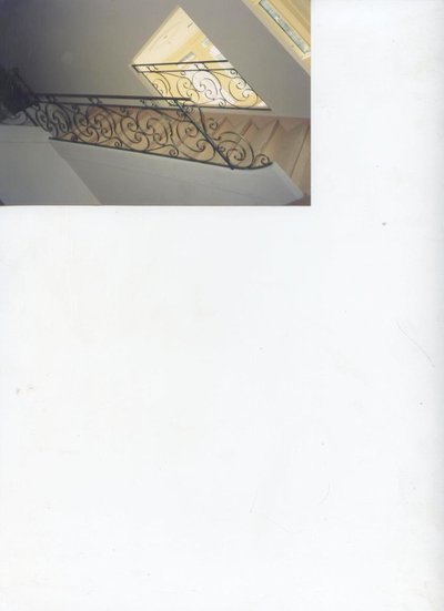 Rampe d'escalier en fer forgé avec volutes